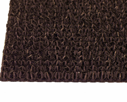 Close-up of artificial turf mat fibers and edge detail