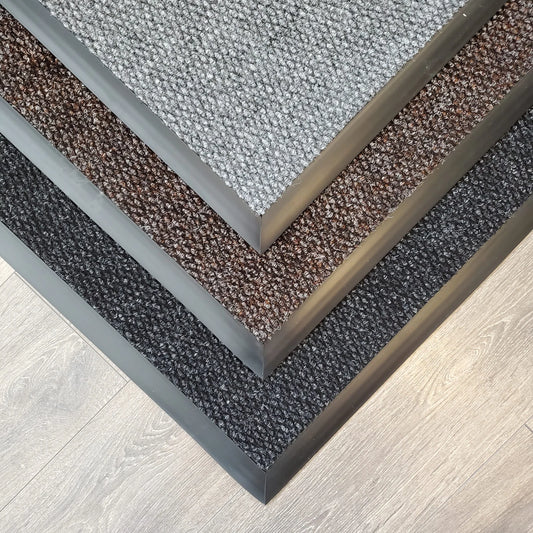 Premium Knob commercial entrance mats displayed in charcoal, grey and chocolate